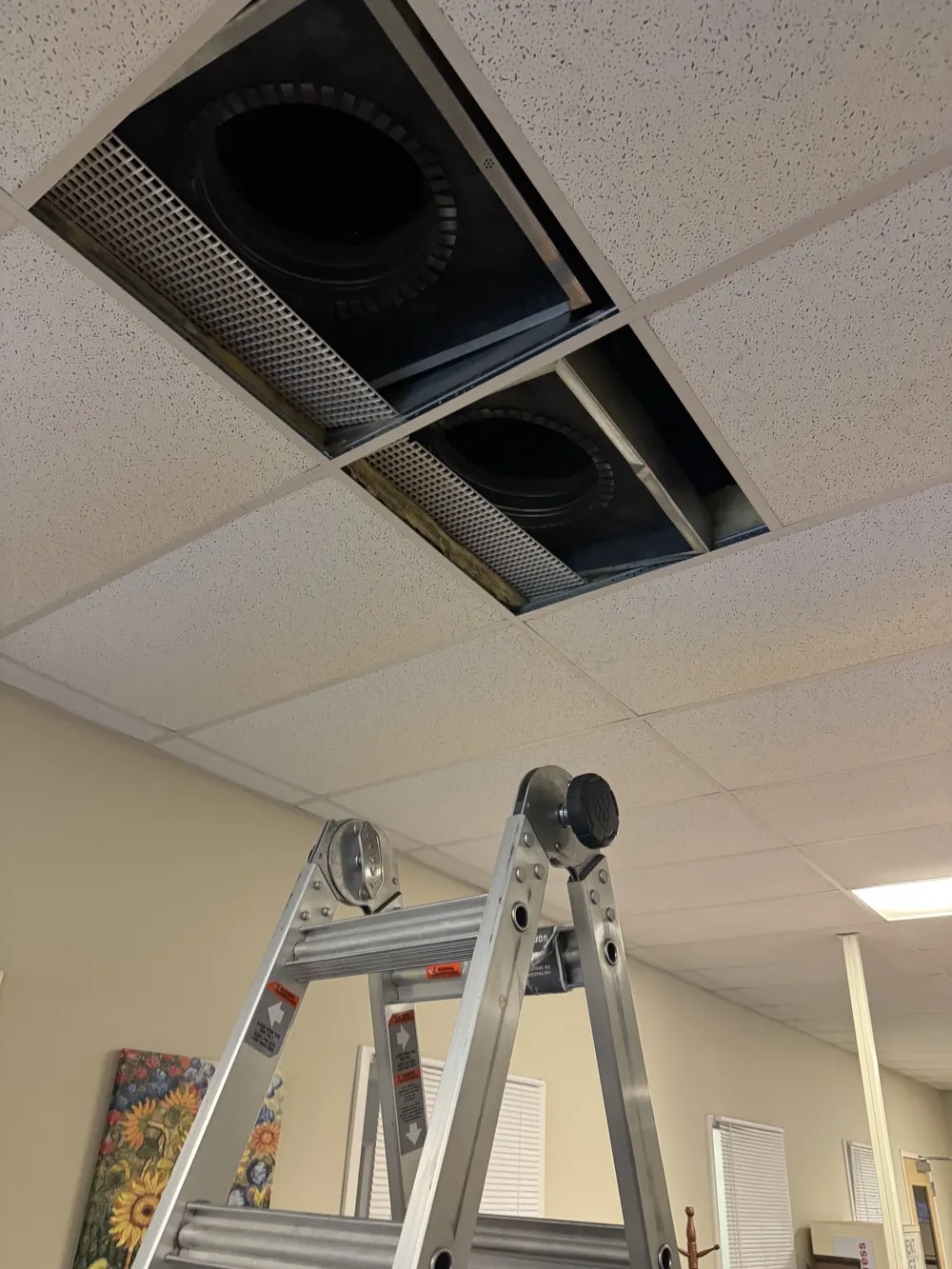 Commercial ceiling vents opened for duct cleaning and inspection
