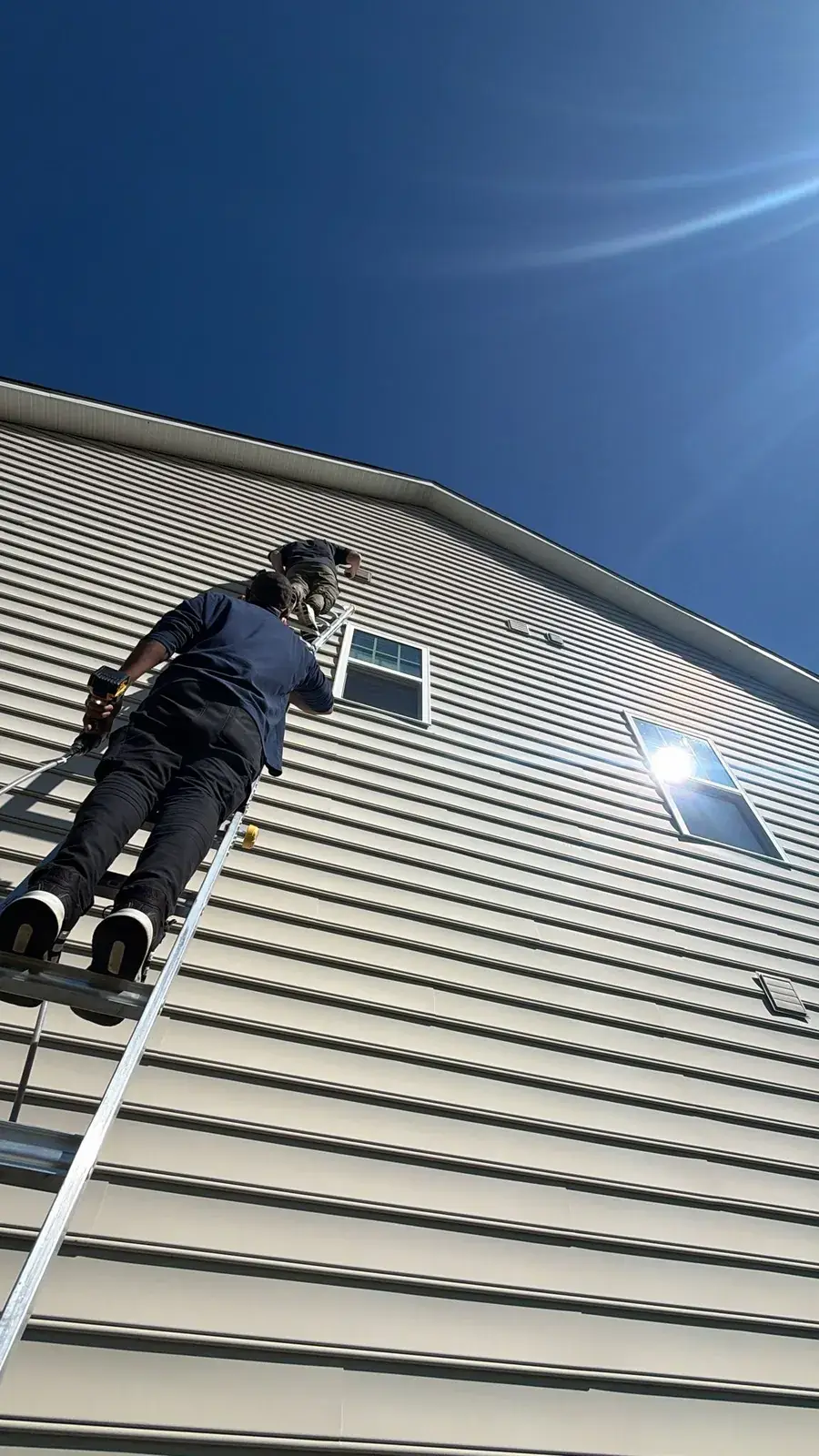 Technician servicing a roof-terminated dryer vent during a cleaning