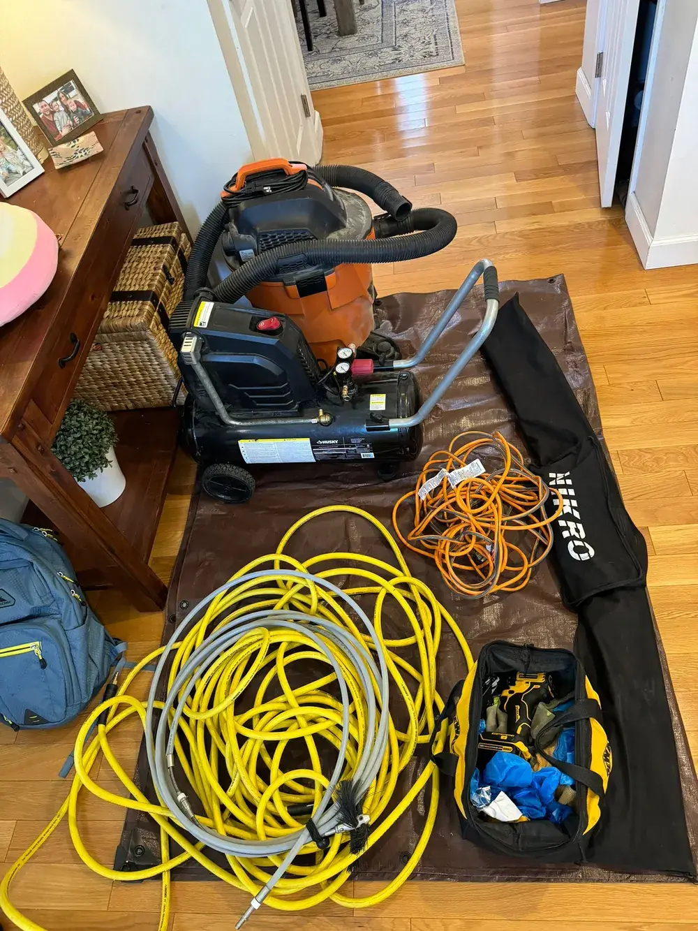 Professional negative-pressure duct cleaning equipment staged and connected at a job site