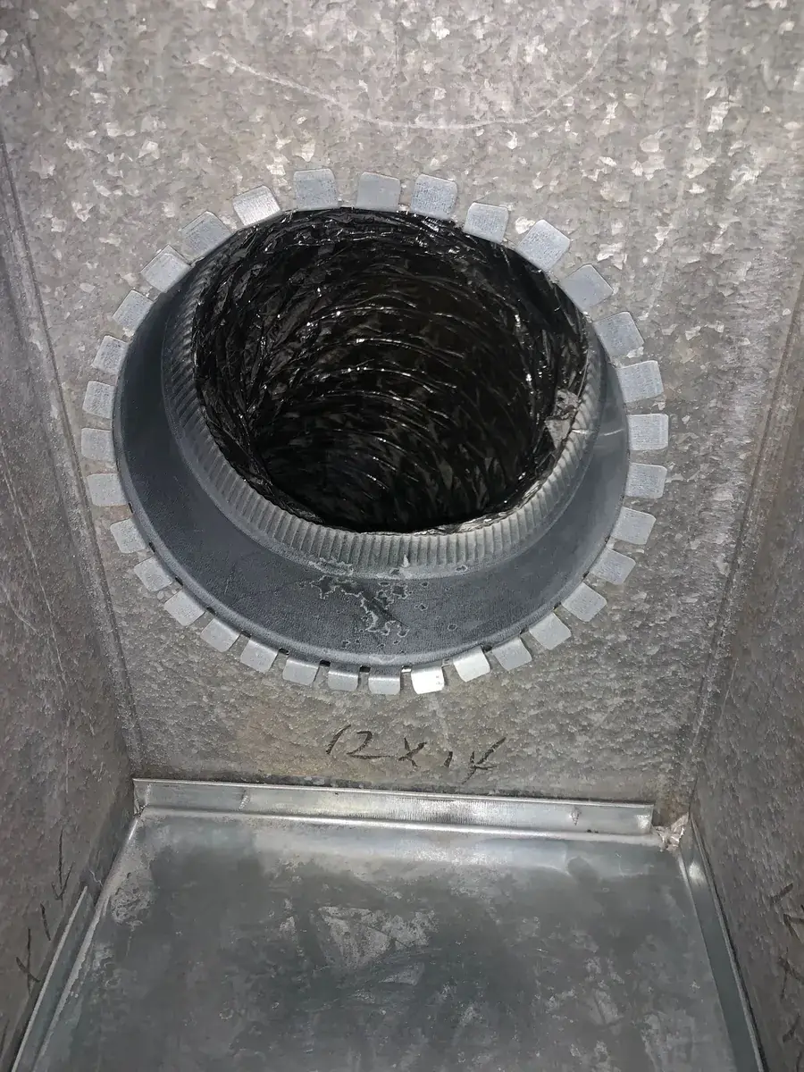 Debris-clogged duct transition uncovered during a source-removal air duct cleaning inspection